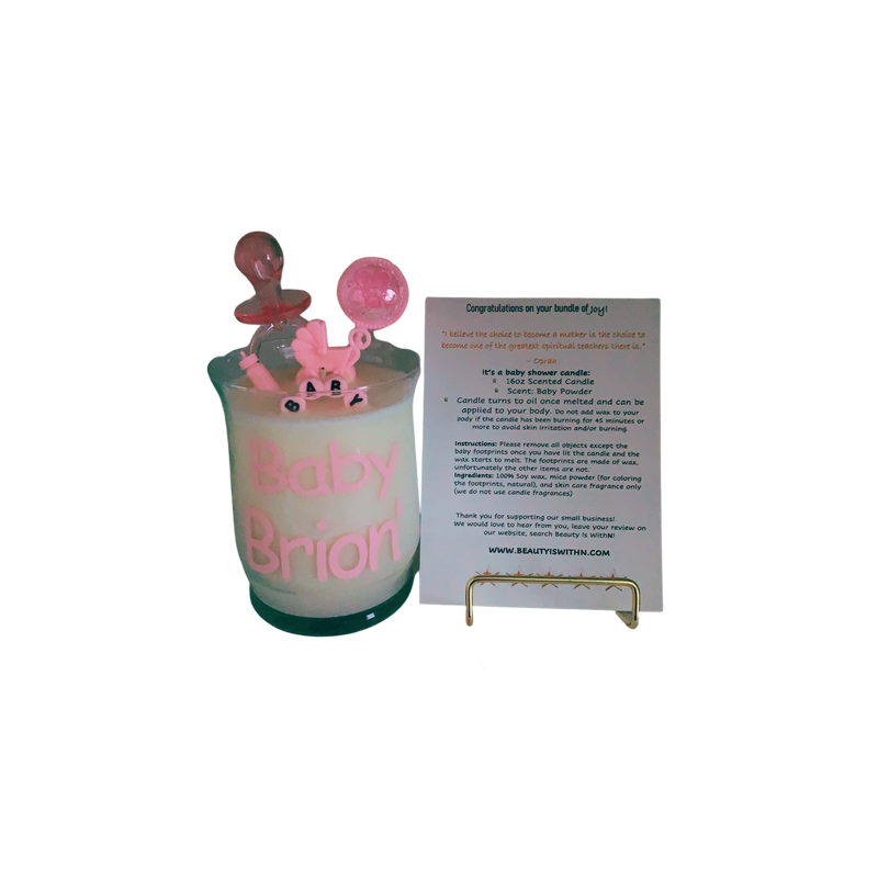 Pink 10oz baby shower candle with 'Baby Girl' topper, wax baby feet, rubber duck, and baby-themed decorations (decorations may vary on availability). Includes an instruction card and customizable label for baby's name. Scent: Baby Powder